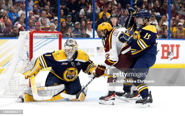 Yaniv Perets of the Quinnipiac Bobcats stops a shot from Bryce Brodzinski of the Minnesota Golden Gophers in the second period during the...