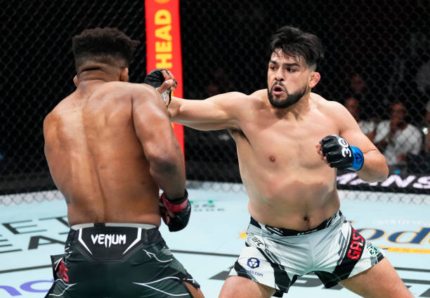 Kelvin Gastelum punches Chris Curtis in a middleweight fight during the UFC 287 event at Kaseya Center on April 08, 2023 in Miami, Florida.