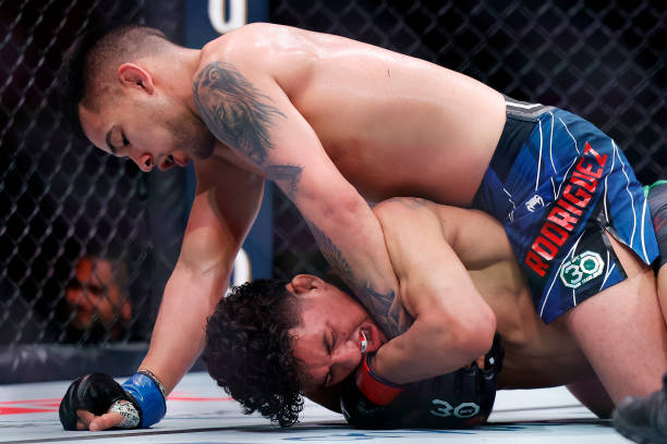 Christian Rodriguez grapples with Raul Rosas Jr. In their bantamweight bout at Kaseya Center on April 08, 2023 in Miami, Florida.