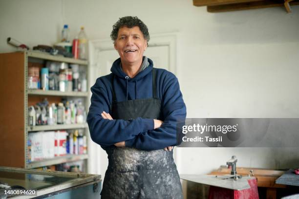 carpenter man, happy portrait and workshop with arms crossed for small business, entrepreneurship and vision. senior woodwork expert, experience and happiness in factory with smile, industry or goals - handyman stockfoto's en -beelden