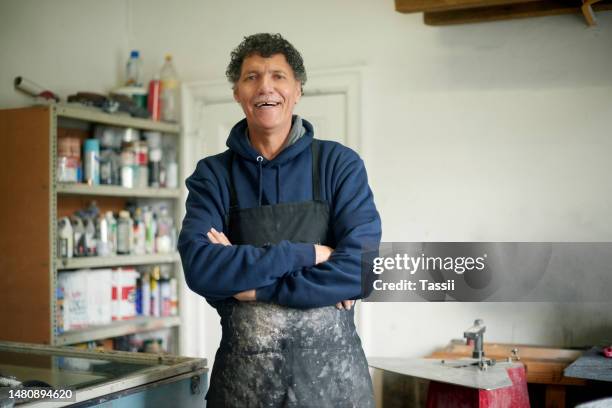 carpenter man, happy portrait and workshop with arms crossed for small business, entrepreneurship and vision. senior woodwork expert, experience and happiness in factory with smile, industry or goals - handyman smiling imagens e fotografias de stock