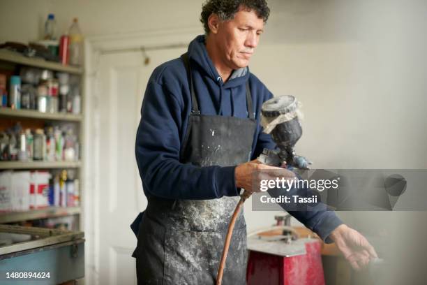 industry, spray machine and man carpenter crafting products for his small business in his workshop. carpentry, equipment and male industrial worker spray painting handicrafts in his studio or shop. - handyman overalls stock pictures, royalty-free photos & images