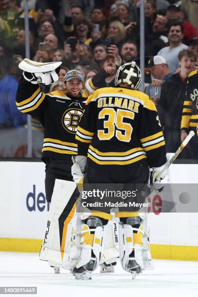 Jeremy Swayman and Linus Ullmark of the Boston Bruins celebrate after defeating the Devils 2-1, tying the NHL single season win record with 62 wins,...