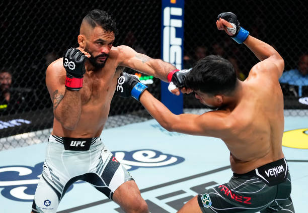 Rob Font punches Adrian Yanez in a bantamweight fight during the UFC 287 event at Kaseya Center on April 08, 2023 in Miami, Florida.