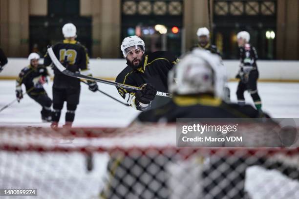 sports, hockey and men playing game, workout or training as a team on an ice rink at stadium. fitness, teamwork and male athletes practicing a strategy, skill or exercise for a match at indoor arena. - professional hockey stock pictures, royalty-free photos & images