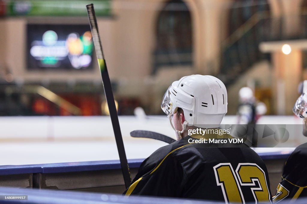 Hockey, arena and team relax in ice rink for sports tournament together in Canada arena. Skate, competition and professional sport people on bench break waiting to play in stadium game.