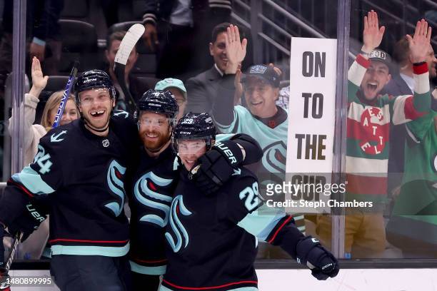 Jamie Oleksiak and Vince Dunn celebrate a goal by Adam Larsson of the Seattle Kraken during the second period against the Chicago Blackhawks at...