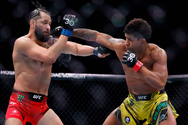 Gilbert Burns of Brazil punches Jorge Masvidal in their welterweight bout during UFC 287 at Kaseya Center on April 08, 2023 in Miami, Florida.