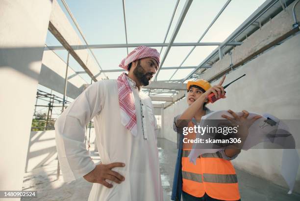 candid shot positive emotion arab investors inspect the construction site with a female adult engineer   on the construction site copy space - succession planning stock pictures, royalty-free photos & images