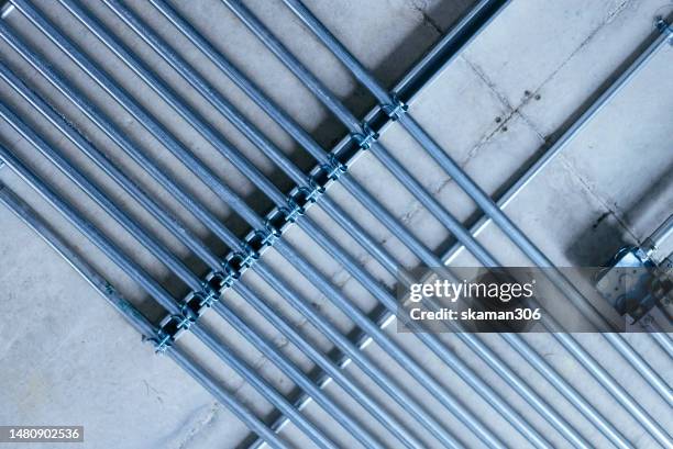 metal tube for electric wire cable and construction material installed on the ceiling  under the construction site - electric piano foto e immagini stock