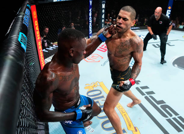 Israel Adesanya of Nigeria punches Alex Pereira of Brazil in the UFC middleweight championship fight during the UFC 287 event at Kaseya Center on...