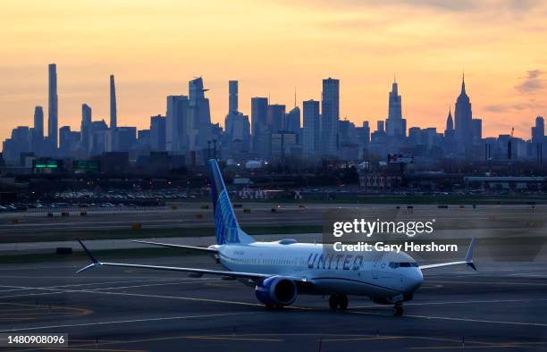 United Airlines airplane makes its way to a gate in front of the skyline of midtown Manhattan in New York City at Newark Liberty Airport on April 8...