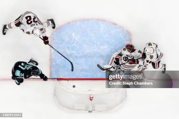 Yanni Gourde of the Seattle Kraken scores a goal against Petr Mrazek of the Chicago Blackhawks during the first period at Climate Pledge Arena on...