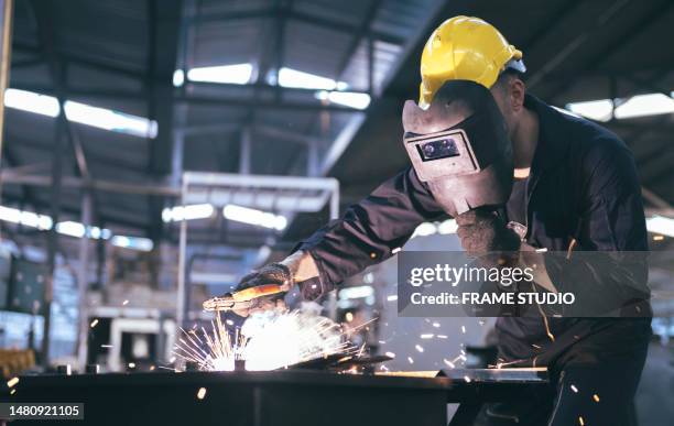 caucasian worker in protective suit with protective mask for welding steel is working welding steel in factory. - metalwork stock-fotos und bilder