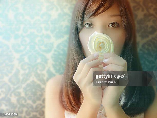 portrait of young woman with white flower - poquoson stock pictures, royalty-free photos & images