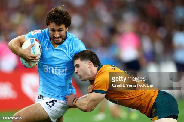 Diego Ardao of Uruguay runs with the ball against Tim Clements of Australia in their 5th place semifinal match during the HSBC Singapore Rugby Sevens...
