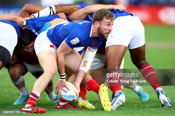 Thibaud Mazzoleni of France looks for a pass out of a scrum against Great Britain in their 5th place semifinal match during the HSBC Singapore Rugby...