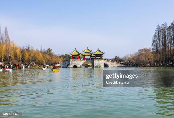 chinese traditional festival: spring festival. yangzhou slender west lake tourist area is bustling with tourists. tourists are taking pleasure boats in the lake. yangzhou city, jiangsu province, china. - yangzhou stock pictures, royalty-free photos & images