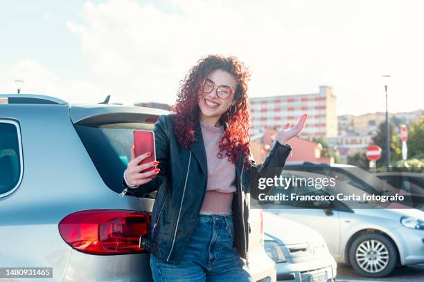 happy young woman take a video call outdoors - free mms stock pictures, royalty-free photos & images