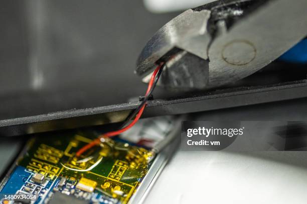 man taking electrical component, cutting wire - dismantling stock pictures, royalty-free photos & images