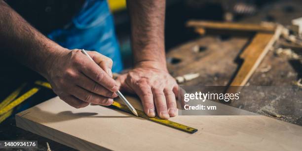 carpenter measuring wood with meter instrument - snickare bildbanksfoton och bilder