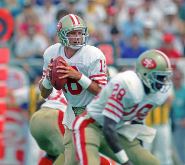 Quarterback Joe Montana of the San Francisco 49ers looks to pass against the Kansas City Chiefs as running back Joe Cribbs blocks during a preseason...