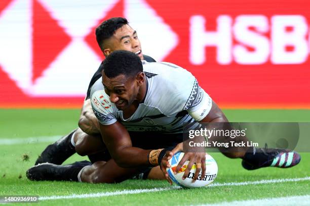 Joseva Talacolo of Fiji scores a try against Regan Ware of New Zealand in their cup semifinal match during the HSBC Singapore Rugby Sevens at the...