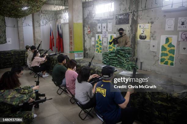 Tourists learn to use guns at the Houlin Laser Shooting range on April 09, 2023 in Kinmen, Taiwan. Kinmen, an island in the Taiwan strait that is...