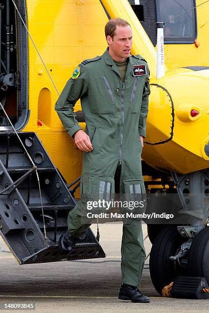 Prince William, Duke of Cambridge disembarks his RAF Search and Rescue Sea King Helicopter after giving his father Prince Charles, Prince of Wales a...