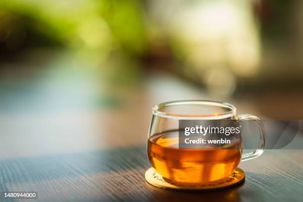 close-up of tea in glass on table - tea leaf stock pictures, royalty-free photos & images