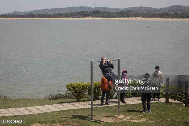 Tourist does pull ups at a display at the Shaxi Fort on April 09, 2023 in Kinmen, Taiwan. Kinmen, an island in the Taiwan strait that is part of...