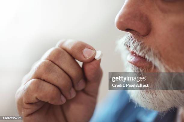 man taking medicaments - taking medication stockfoto's en -beelden