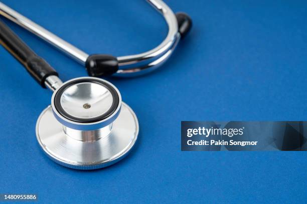 stethoscopes against a blue background. - phonendoscope stock pictures, royalty-free photos & images