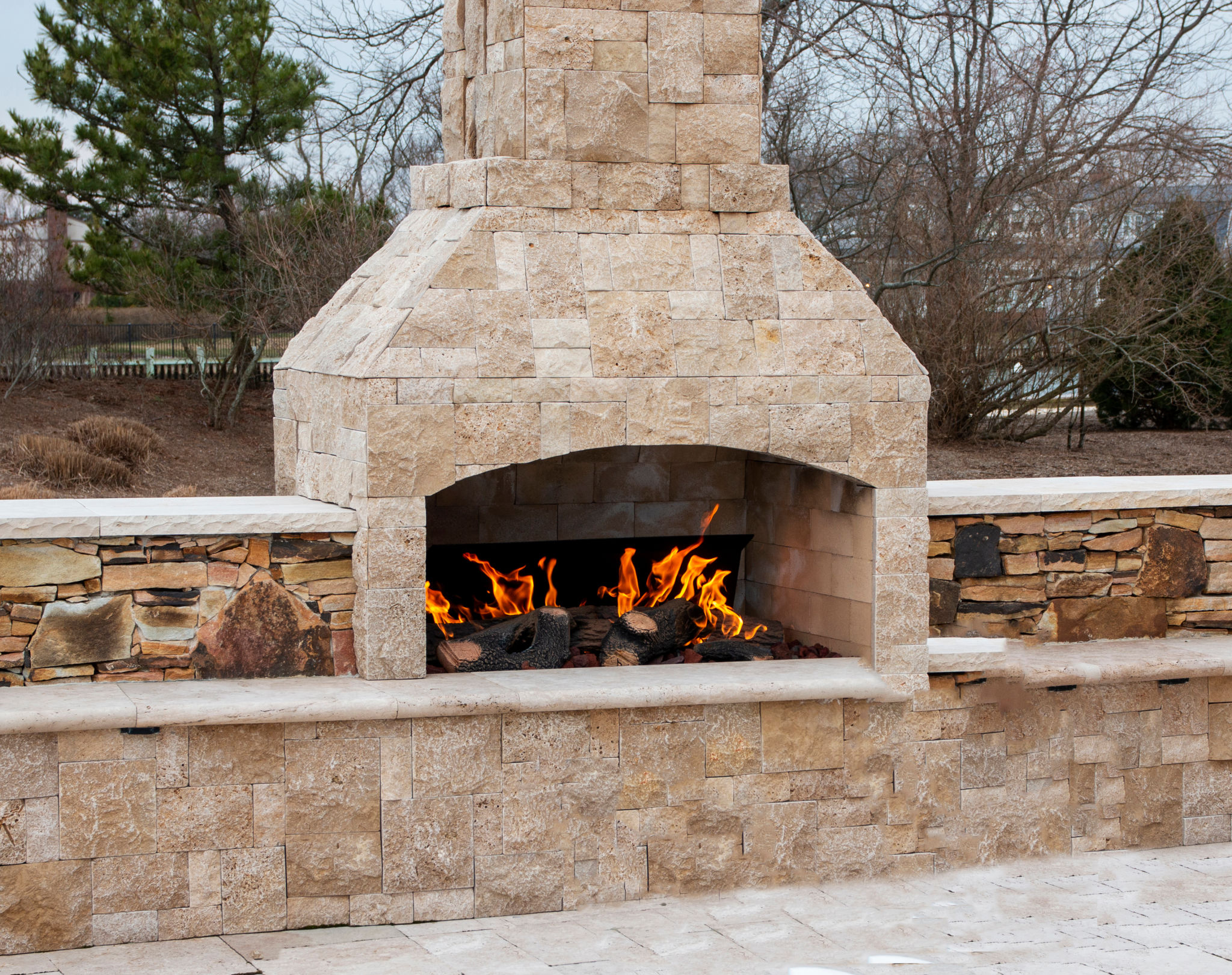 Paving stone fireplace burning on deck Paving stone fireplace burning on deck