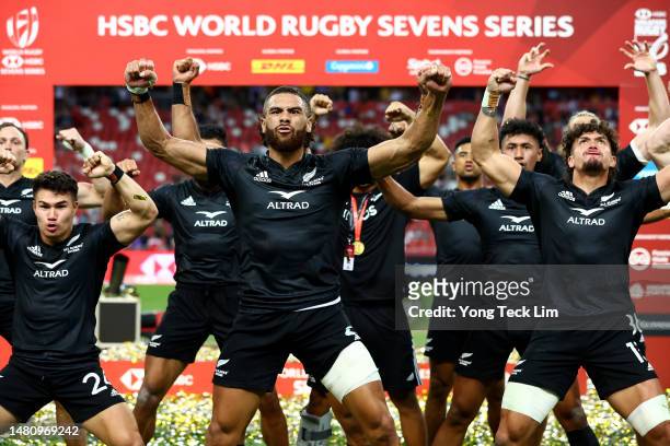 The New Zealand team celebrates with a haka after winning the cup final match against Argentina during the HSBC Singapore Rugby Sevens at the...