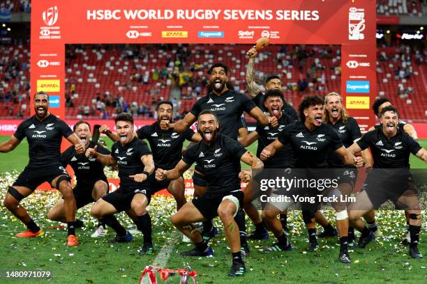 The New Zealand team celebrates with a haka after winning the cup final match against Argentina during the HSBC Singapore Rugby Sevens at the...
