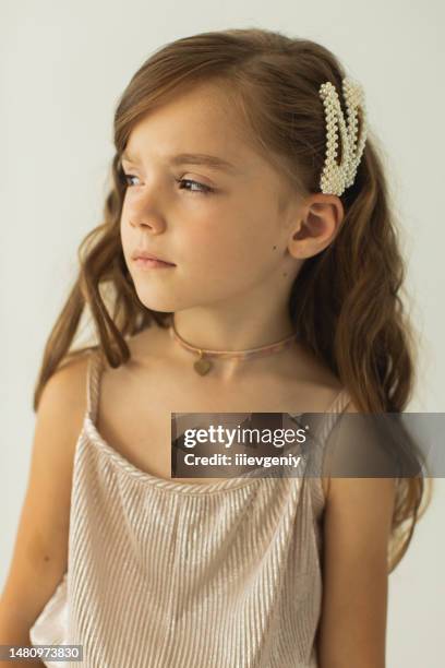 blonde girl in silver dress in studio on white background. suit - hair clip stock pictures, royalty-free photos & images