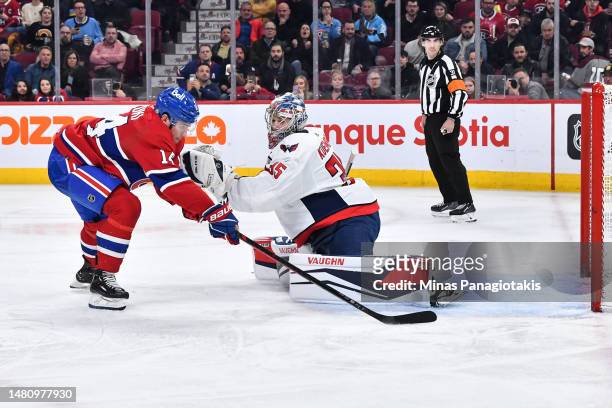 Nick Suzuki of the Montreal Canadiens skates the puck around goaltender Darcy Kuemper of the Washington Capitals during the second period at Centre...
