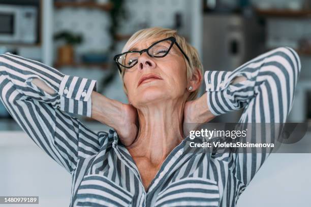 senior woman suffering from neckache. - hernia stock pictures, royalty-free photos & images