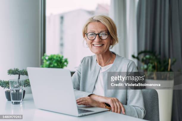 successful businesswoman in modern office working on laptop. - unemployed marketing professional searches for a job stock pictures, royalty-free photos & images