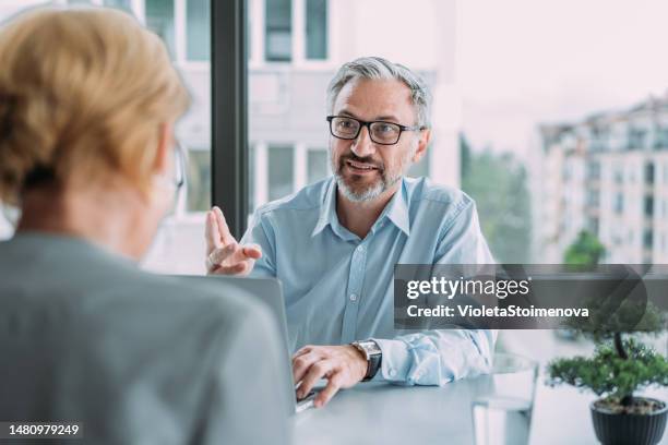 business partners in meeting. - real estate agent male stock pictures, royalty-free photos & images