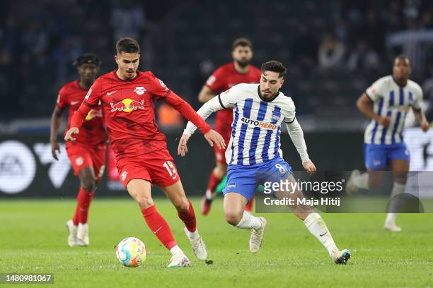Suat Serdar of Hertha BSC battles for possession with André Silva of RB Leipzig during the Bundesliga match between Hertha BSC and RB Leipzig at...