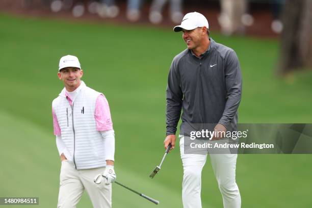 Amateur Sam Bennett of the United States and Brooks Koepka of the United States look on from the tenth green during the continuation of the weather...