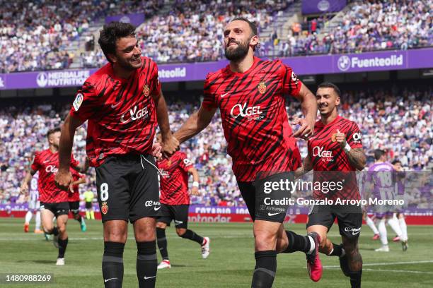 Vedat Muriqi of RCD Mallorca celebrates with teammates after scoring the team's third goal during the LaLiga Santander match between Real Valladolid...