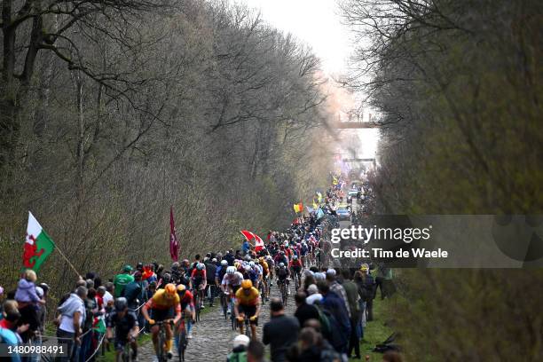 General view of the peloton passing through the Trouée d'Arenberg cobblestones sector during the 120th Paris-Roubaix 2023, Men's Elite a 256.6km one...