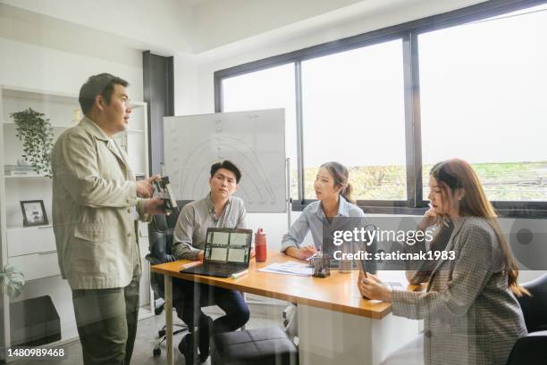 asian man engineer presenting about the work of solar panel to his colleagues during business meeting at office. - waste management office stock pictures, royalty-free photos & images