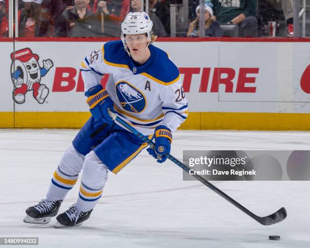 Rasmus Dahlin of the Buffalo Sabres skates up ice with the puck against the Detroit Red Wings during the first period of an NHL game at Little...