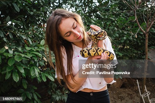 Young woman and her pet snake Young woman and her pet snake