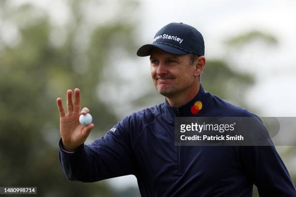 Justin Rose of England reacts to his putt on the 18th green during the continuation of the weather delayed third round of the 2023 Masters Tournament...