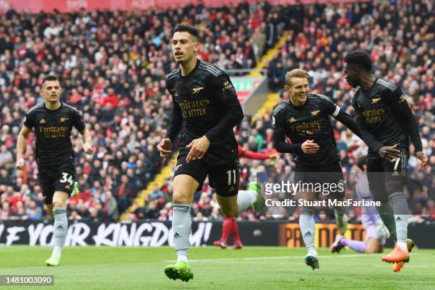 Gabriel Martinelli of Arsenal celebrates after scoring the team's first goal with teammates during the Premier League match between Liverpool FC and...